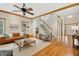 Spacious living room with hardwood floors, fireplace, stairs and large windows at 109 Homegate Cir, Apex, NC 27502
