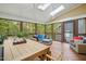 Relaxing sunroom with wood floors, neutral furniture, ceiling fans, and natural light at 109 Homegate Cir, Apex, NC 27502