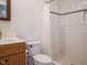 Bright bathroom features tiled shower, neutral paint and modern vanity at 110 Streamside Dr, Sanford, NC 27330