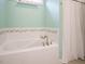 A relaxing bathtub with a tile surround and a shower at 110 Streamside Dr, Sanford, NC 27330