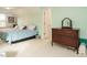 A spacious bedroom with two beds, carpeted floors, and a classic dresser at 110 Streamside Dr, Sanford, NC 27330