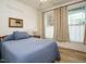 Cozy bedroom with two windows, wood floors, and a comfortable bed at 110 Streamside Dr, Sanford, NC 27330