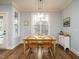 A bright dining room with wood table and flooring at 110 Streamside Dr, Sanford, NC 27330