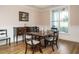 Elegant dining room with classic furniture, wainscoting, and a large window at 110 Streamside Dr, Sanford, NC 27330
