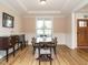 Elegant dining room with classic furniture, wainscoting, and a large window at 110 Streamside Dr, Sanford, NC 27330