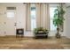 Bright entryway featuring hardwood floors, a console table, and a tall indoor plant near large windows at 110 Streamside Dr, Sanford, NC 27330