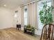 Inviting entryway with hardwood floors, a console table, and ample natural light from large windows at 110 Streamside Dr, Sanford, NC 27330