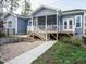 Beautiful exterior view of the home, featuring a patio, screened porch, and well-maintained landscaping at 110 Streamside Dr, Sanford, NC 27330