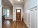 Bright foyer featuring a wooden front door, beautiful floors, and elegant wainscoting at 110 Streamside Dr, Sanford, NC 27330
