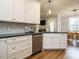Kitchen has custom cabinets, stainless steel appliances, and hardwood floors at 110 Streamside Dr, Sanford, NC 27330
