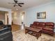 Open living room with a view into the foyer and hallway, featuring a fireplace and comfortable seating at 110 Streamside Dr, Sanford, NC 27330