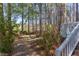 Tranquil backyard with stone path leading to the deck and a landscaped yard at 111 Fox View Pl, Cary, NC 27511