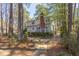 Beautiful backyard with a wooden deck, stone bird bath, and manicured garden space at 111 Fox View Pl, Cary, NC 27511