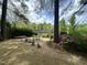 Beautiful backyard with a sitting area, lush landscaping, and a serene lake view at 111 Fox View Pl, Cary, NC 27511