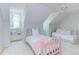 Attic bedroom featuring vaulted ceiling, twin beds and dormer window seat at 111 Fox View Pl, Cary, NC 27511