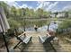 Relaxing dock area with chairs and potted flowers overlooking the tranquil lake at 111 Fox View Pl, Cary, NC 27511
