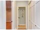 Hallway with access to a laundry room, and a view into another room with hardwood floors at 111 Fox View Pl, Cary, NC 27511