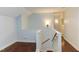 Bright hallway with hardwood floors, white trim, and classic wall sconces at 111 Fox View Pl, Cary, NC 27511