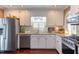 Updated kitchen featuring stainless steel appliances, bright counter tops, and white cabinetry at 111 Fox View Pl, Cary, NC 27511