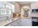 Stylish kitchen showcasing white cabinetry, stainless steel appliances, and natural lighting at 111 Fox View Pl, Cary, NC 27511