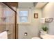 Walk-in shower with stone tile walls and a glass enclosure at 111 Fox View Pl, Cary, NC 27511