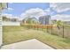 A spacious backyard featuring a black metal fence, a concrete patio, and green grass at 1112 Addington Lake Ln, Knightdale, NC 27545