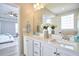 Double sink bathroom vanity with framed mirror, white cabinets and neutral paint at 1112 Addington Lake Ln, Knightdale, NC 27545