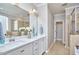 Bright bathroom featuring double vanity with white cabinets and a separate glass-enclosed shower and tub at 1112 Addington Lake Ln, Knightdale, NC 27545