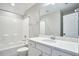 Bright bathroom features a shower-tub combo with white tile and a vanity with a white countertop at 1112 Addington Lake Ln, Knightdale, NC 27545