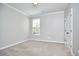 Bedroom featuring neutral carpet and a single window providing ample natural light at 1112 Addington Lake Ln, Knightdale, NC 27545