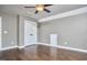 Bedroom featuring wood floors, a ceiling fan, and a double-door closet for ample storage space at 1112 Addington Lake Ln, Knightdale, NC 27545
