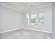 Neutral bedroom with three windows offering ample natural light and plush carpeting at 1112 Addington Lake Ln, Knightdale, NC 27545