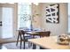 Eat-in kitchen dining area with decoratively set table and chairs next to a door at 1112 Addington Lake Ln, Knightdale, NC 27545