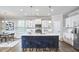 Modern kitchen with a large island, stainless steel appliances, and sleek countertops at 1112 Addington Lake Ln, Knightdale, NC 27545