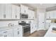 Clean kitchen with white cabinets, stainless steel appliances, and modern design at 1112 Addington Lake Ln, Knightdale, NC 27545