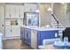 Kitchen featuring a central island, stainless steel appliances and access to a staircase at 1112 Addington Lake Ln, Knightdale, NC 27545