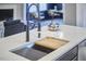 Kitchen island with stainless steel faucet and a cutting board at 1112 Addington Lake Ln, Knightdale, NC 27545
