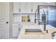 Modern kitchen with stainless steel appliances, white cabinets and counters, and matte black hardware at 1112 Addington Lake Ln, Knightdale, NC 27545