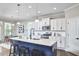 Bright kitchen with white cabinets, stainless steel appliances, and a large island with bar seating at 1112 Addington Lake Ln, Knightdale, NC 27545