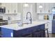 Modern kitchen with white countertops, island with seating, and stainless steel appliances at 1112 Addington Lake Ln, Knightdale, NC 27545