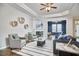 Relaxing living room with a fireplace, large windows, and comfortable seating arrangement at 1112 Addington Lake Ln, Knightdale, NC 27545