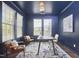 Office with navy walls and trim, area rug, a desk, and 3 chairs at 1112 Addington Lake Ln, Knightdale, NC 27545
