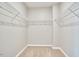 Spacious walk-in closet with carpet flooring and shelving ready for customizable storage solutions at 1112 Addington Lake Ln, Knightdale, NC 27545