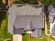 Aerial view of a home with a gray roof, green lawn, and surrounding trees at 113 Glenmore Rd, Chapel Hill, NC 27516