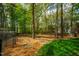 Landscaped backyard featuring a fire pit, woodchips, and a natural wooded area at 113 Glenmore Rd, Chapel Hill, NC 27516