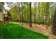 Expansive backyard blending green lawn and a wooded area, complete with a charming deck at 113 Glenmore Rd, Chapel Hill, NC 27516