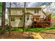 Spacious backyard with a wooden deck, lush lawn, and mature trees for added privacy at 113 Glenmore Rd, Chapel Hill, NC 27516