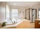 Relaxing bathroom features soaking tub, glass-enclosed shower, and neutral tile at 113 Glenmore Rd, Chapel Hill, NC 27516