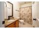 Neutral toned bathroom featuring a granite-topped vanity and a shower with a decorative curtain at 113 Glenmore Rd, Chapel Hill, NC 27516