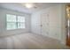 Clean bedroom featuring carpet flooring, white trim, and window at 113 Glenmore Rd, Chapel Hill, NC 27516